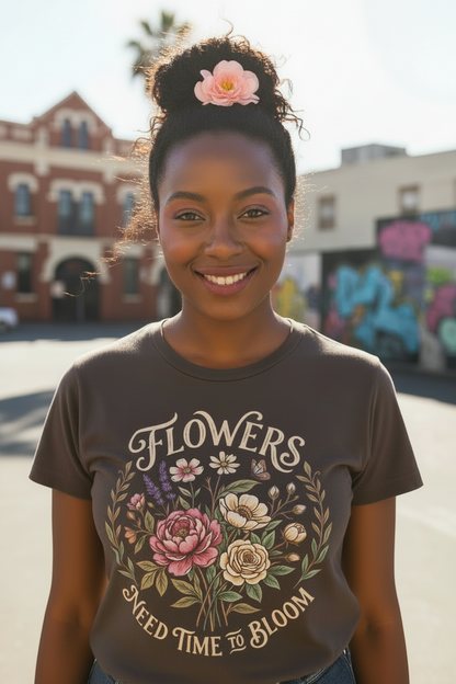 Woman wearing a t-shirt with floral design and text, standing outdoors.