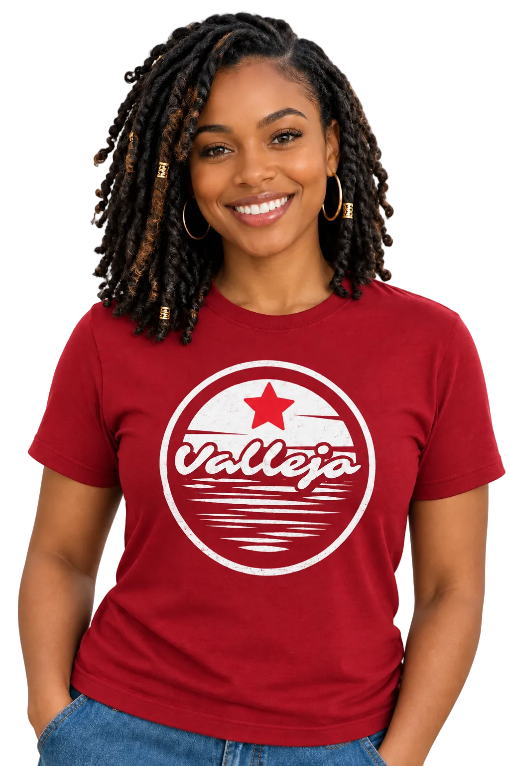 A smiling woman with braided hair wearing a red crewneck t-shirt with a white circular 'Vallejo' graphic on the chest, paired with blue jeans, against a solid white background.